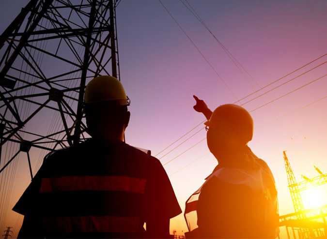 Friendly electrician explaining service to homeowner in Coquitlam